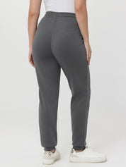 Person wearing gray sweatpants on a white background