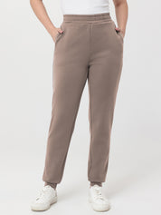 Beige pants worn by a person on a white background