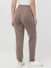 Brown pants worn by a person on a white background