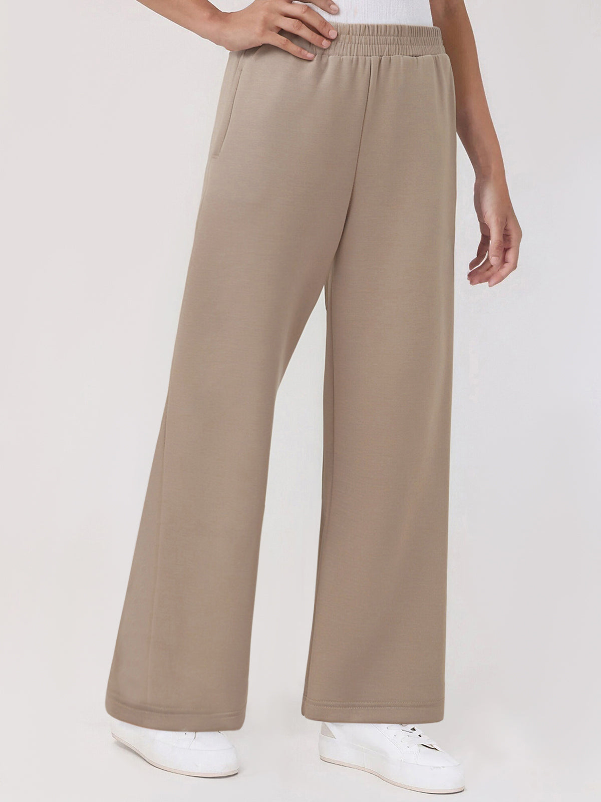 Beige wide-leg pants worn by a person on a white background