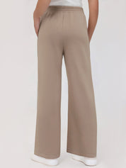 Beige wide-leg pants worn by a person on a white background
