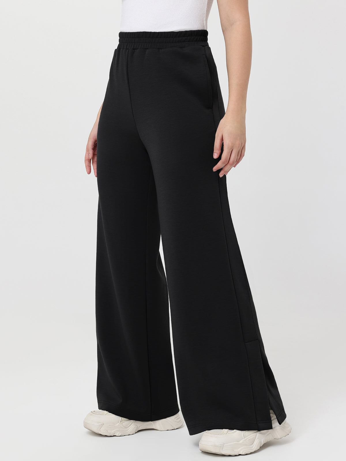 Black wide-leg pants worn by a person on a white background