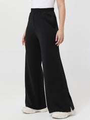 Black wide-leg pants worn by a person on a white background