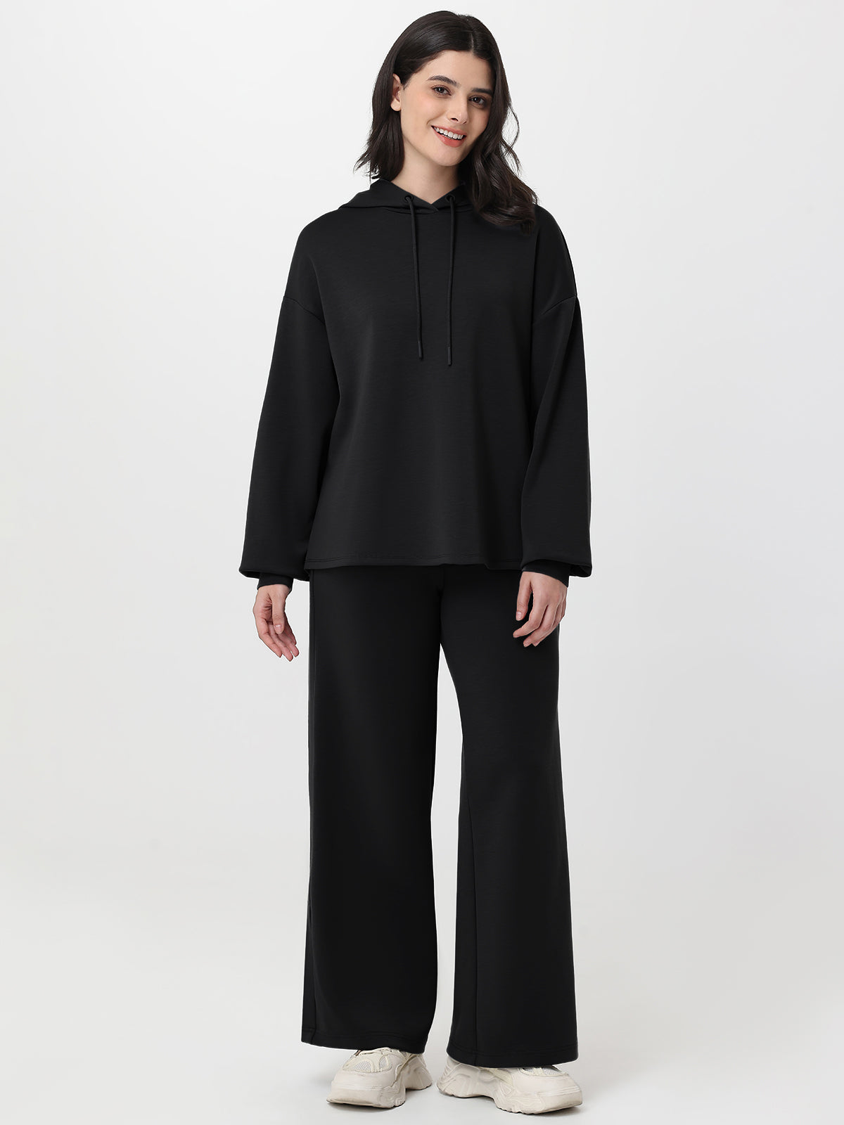 Woman wearing a black outfit on a white background