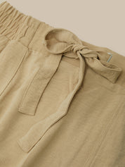 Beige pants with a tie detail on a beige background