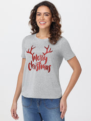 Woman wearing a gray t-shirt with 'Merry Christmas' and reindeer antlers design on a white background