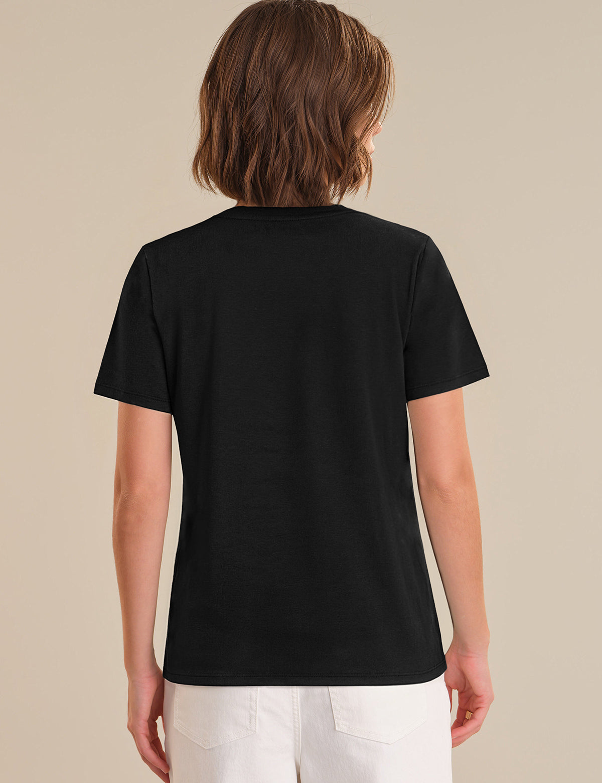 Person wearing a black t-shirt on a beige background