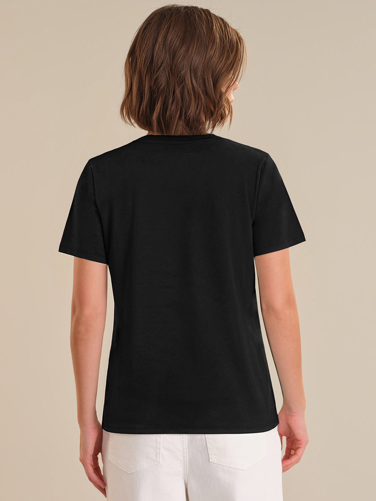 Person wearing a black t-shirt on a beige background