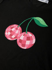 Black t-shirt with pink checkered cherries design on a plain background