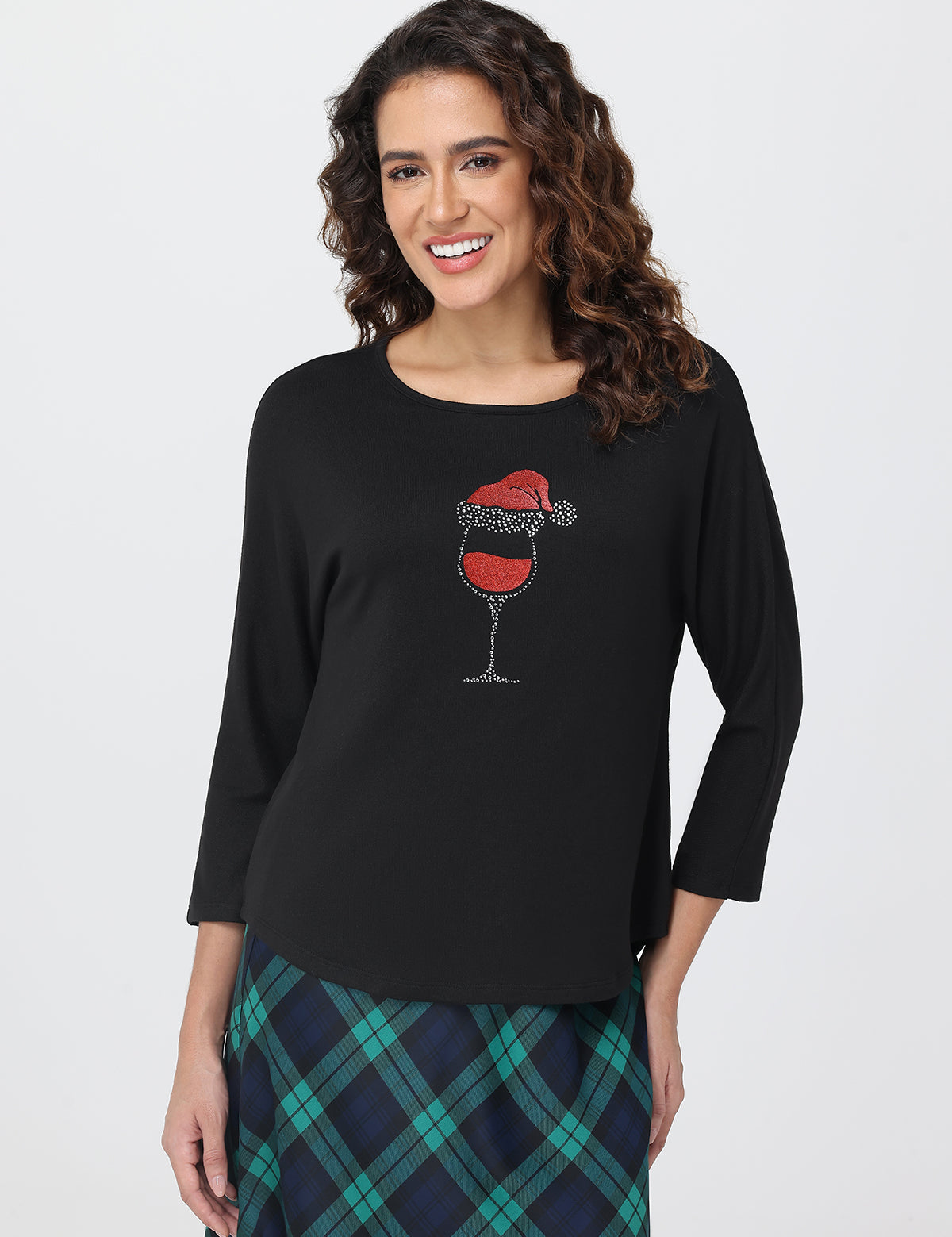 Woman wearing a black long-sleeve shirt with a wine glass design on a white background
