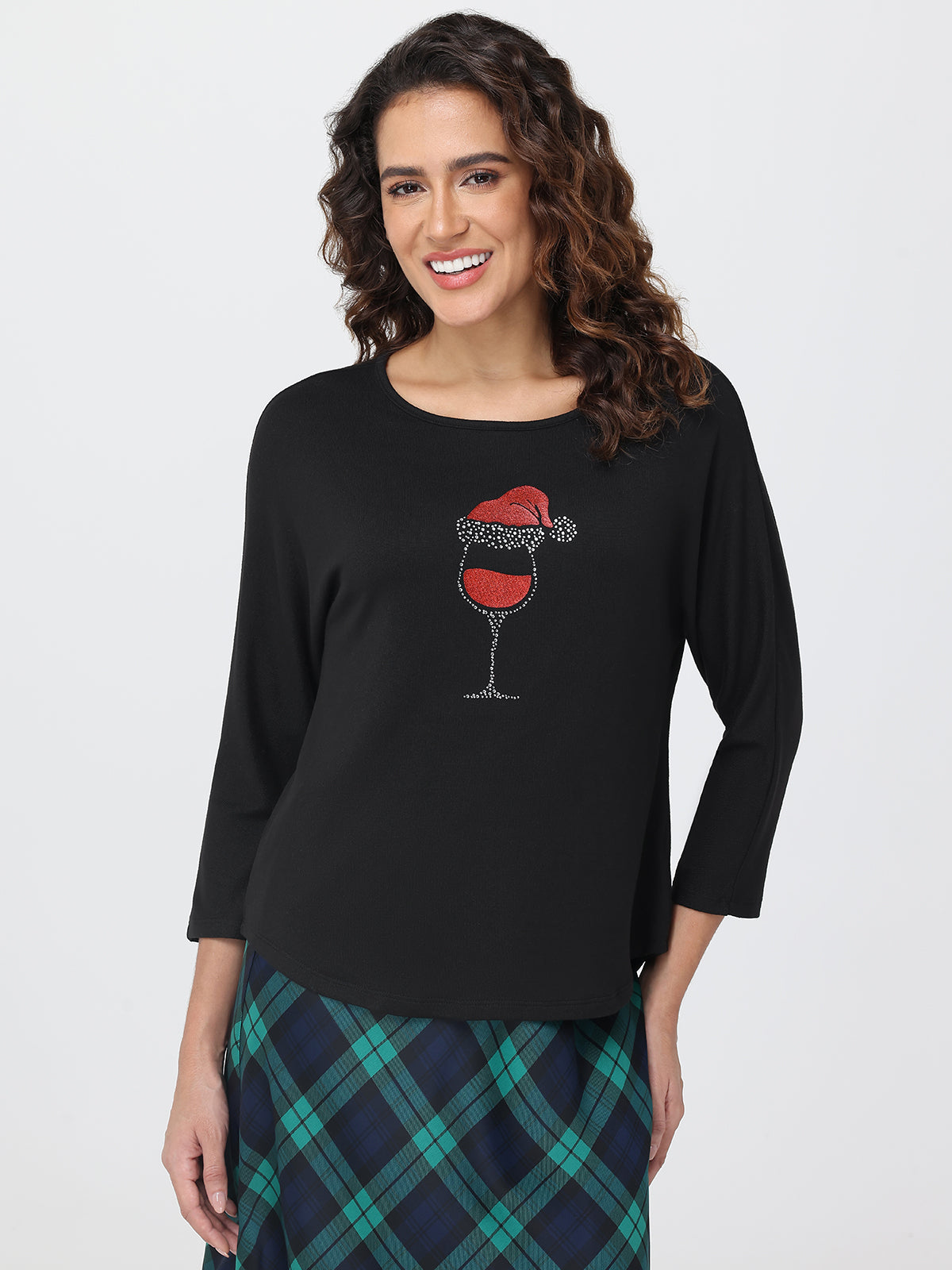 Woman wearing a black long-sleeve shirt with a wine glass design on a white background