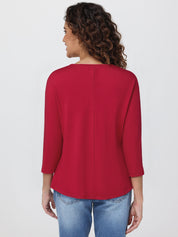 Woman wearing a red top and blue jeans on a white background