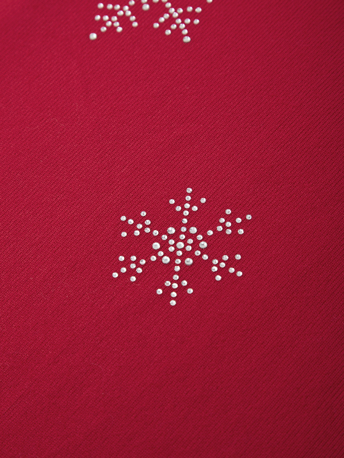 Red fabric with white snowflake patterns