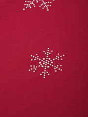Red fabric with white snowflake patterns