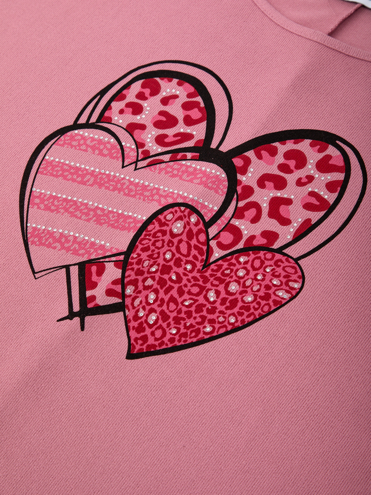 Pink sweatshirt with heart designs featuring leopard print and stripes on a pink background