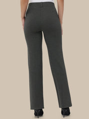 Dark gray pants worn by a person on a beige background