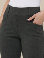 Dark gray pants with a white top on a neutral background