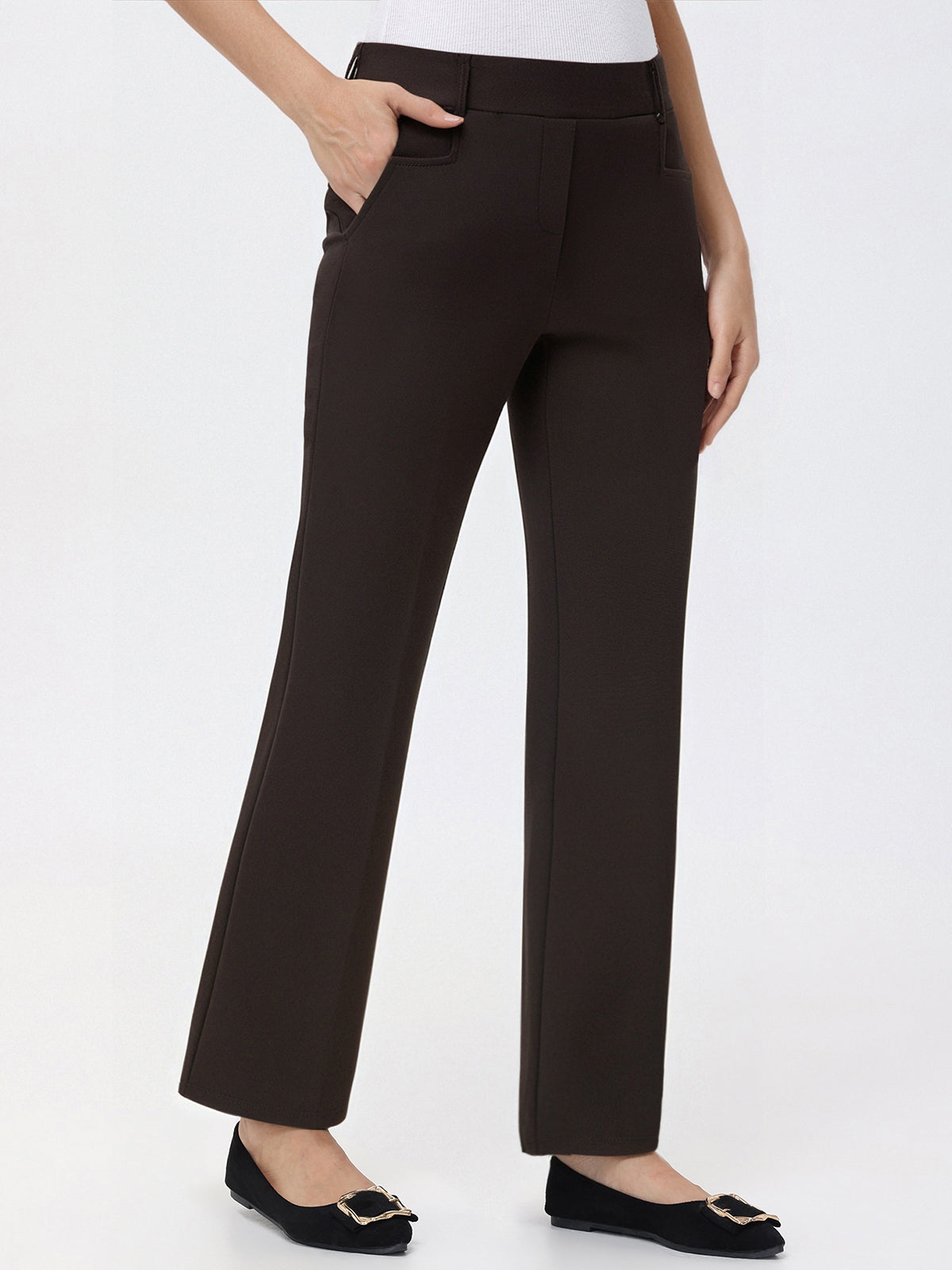 Brown pants worn by a person on a white background