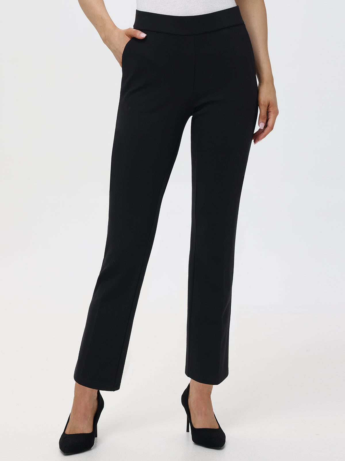 A model wearing black mid-rise front slant pocket flare pants with elastic waistband.