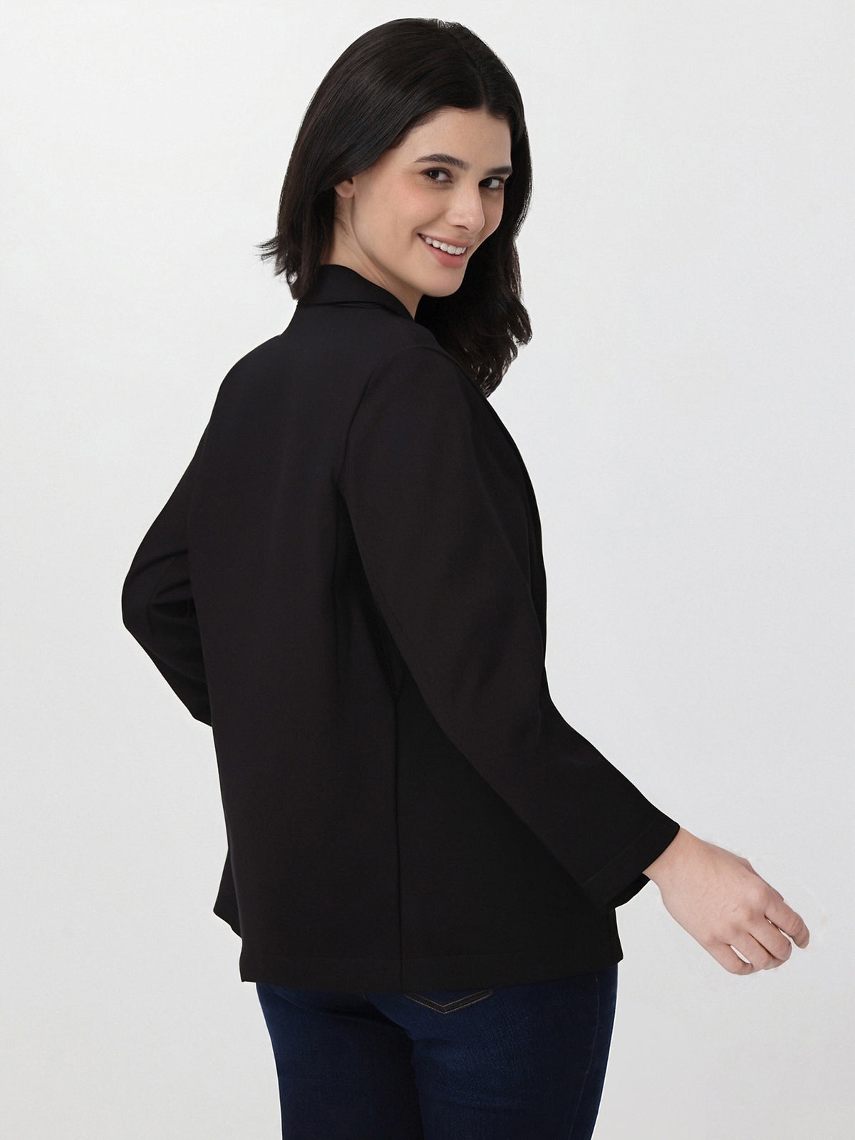 Woman wearing a black blazer on a white background
