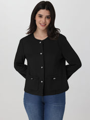 Woman wearing a black jacket with silver buttons on a white background