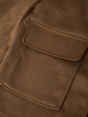 Close-up of a brown suede or nubuck jacket with a flap pocket, showing the soft texture and matching brown stitching.