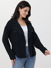 Woman wearing a black jacket over a white top and blue jeans on a white background