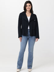 Woman wearing a black jacket and blue jeans on a white background