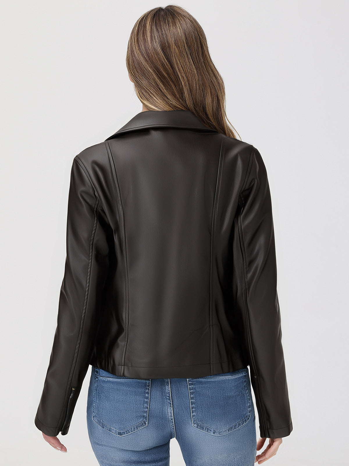 Person wearing a black leather jacket and blue jeans on a white background
