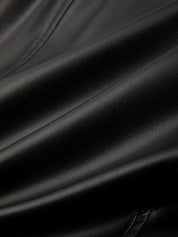 Close-up of black leather fabric with folds