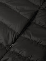 Close-up of a black quilted puffer jacket showing the padded stitching and smooth fabric texture.