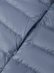 Close-up of a quilted puffer jacket in a muted slate blue-gray color, showing the texture and stitching details.