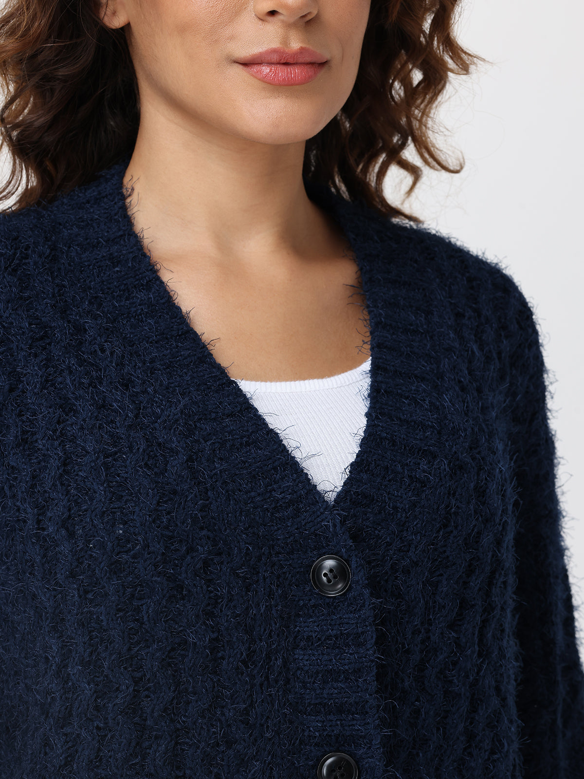 Navy blue cardigan worn by a person on a white background