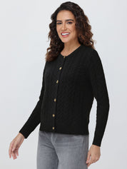 Woman wearing a black cardigan with gold buttons on a white background