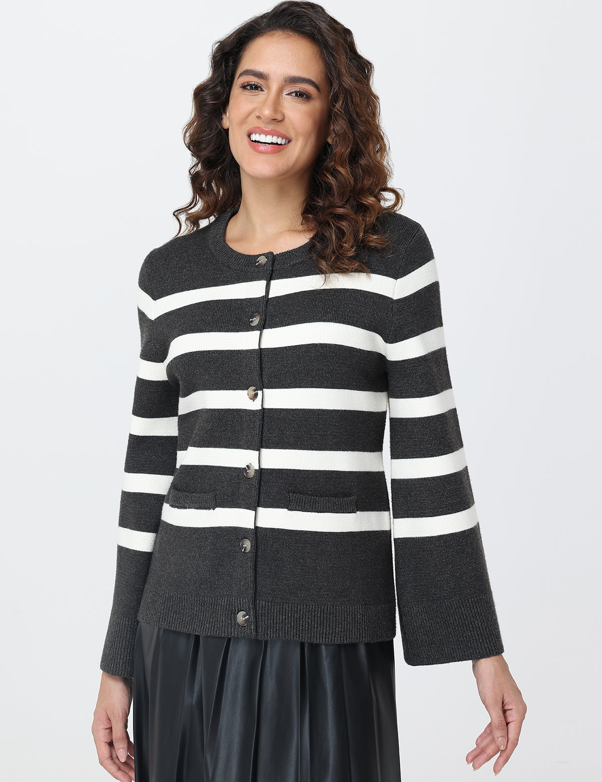 Woman wearing a black and white striped cardigan on a white background