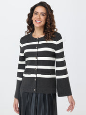 Woman wearing a black and white striped cardigan on a white background
