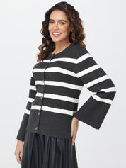 Woman wearing a black and white striped cardigan on a white background