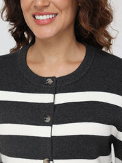Close-up of a person wearing a black and white striped cardigan with a neutral background