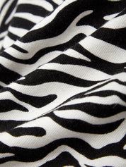 Close-up of zebra pattern fabric with black and white stripes.