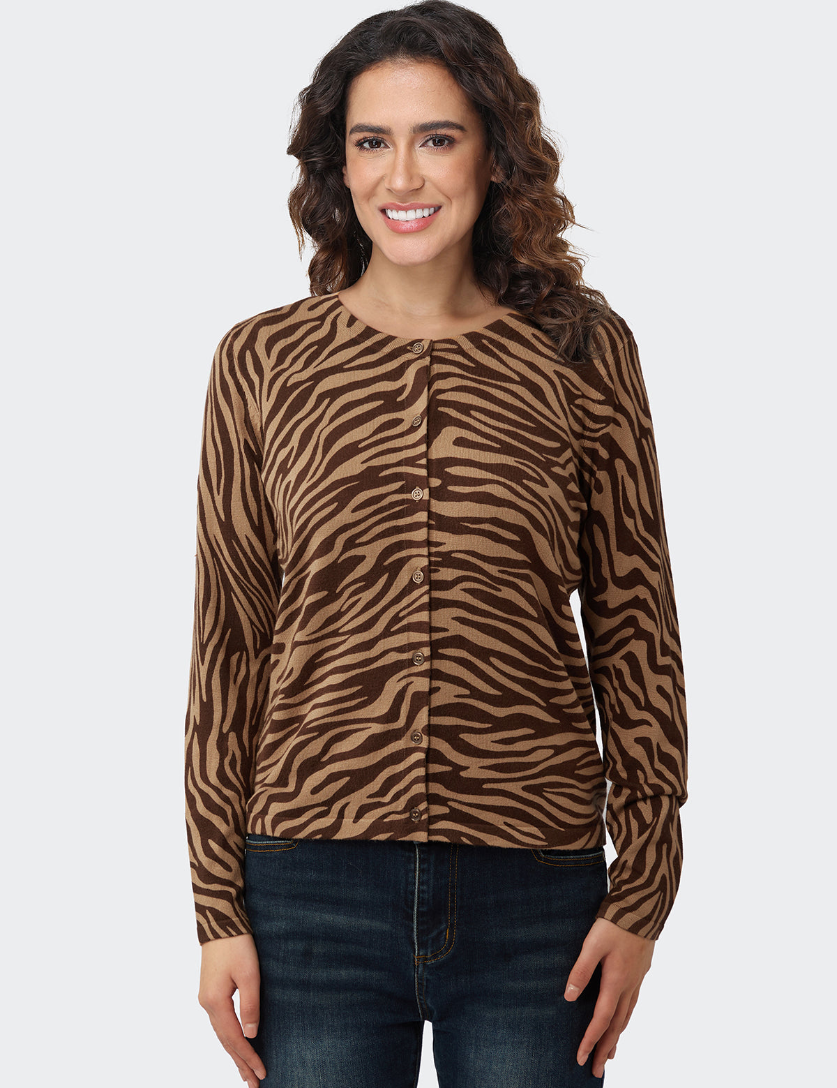 Woman wearing a brown zebra print cardigan on a white background