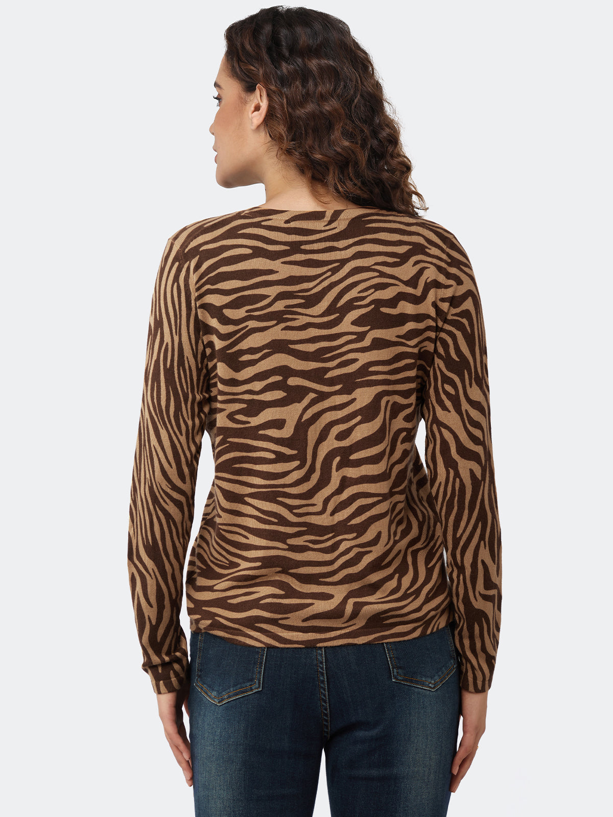 Woman wearing a brown zebra print long-sleeve top on a white background