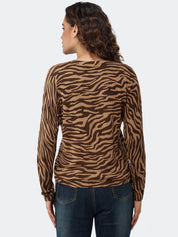 Woman wearing a brown zebra print long-sleeve top on a white background