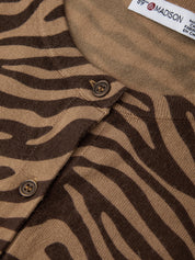 Close-up of a brown fabric with zebra pattern and a visible brand label.