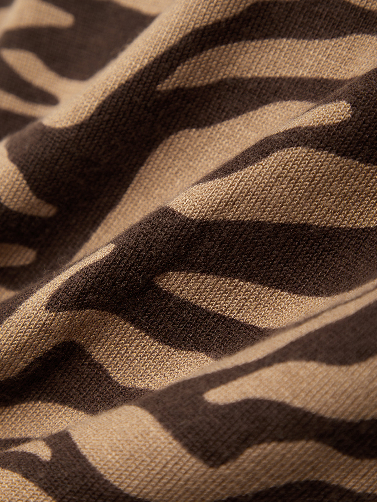 Close-up of brown fabric with black zigzag pattern