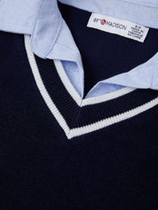 Close-up of a navy sweater with light blue collar and '87 & MADISON' label.