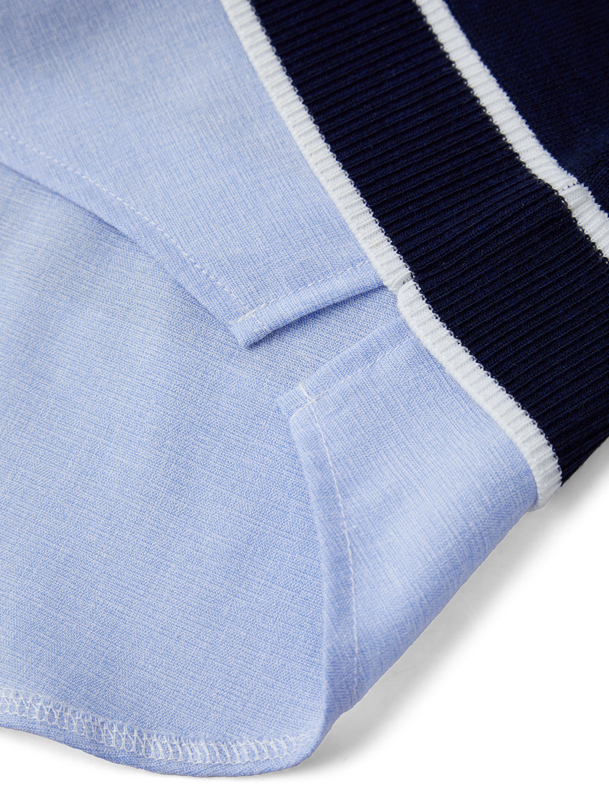 Close-up of a light blue fabric with a navy border on a white background