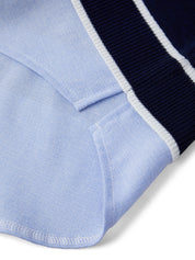 Close-up of a light blue fabric with a navy border on a white background