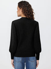 Person wearing a black sweater and blue jeans on a white background