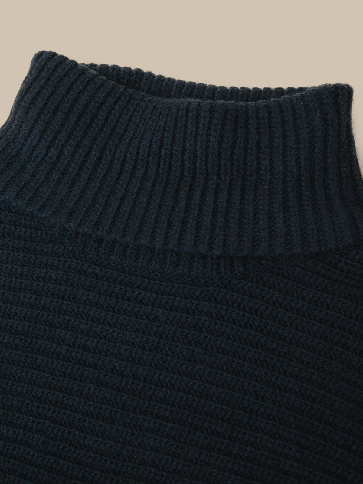 Dark gray pants with a close-up of the waistband on a white background