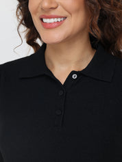 Close-up of a person wearing a black polo shirt with a blurred background